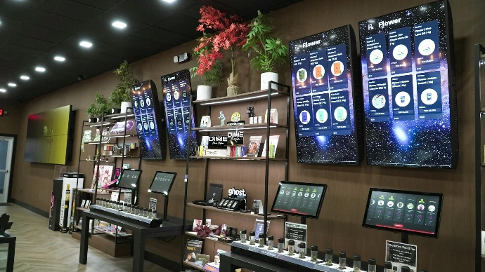 Retail store display with products and screens.
